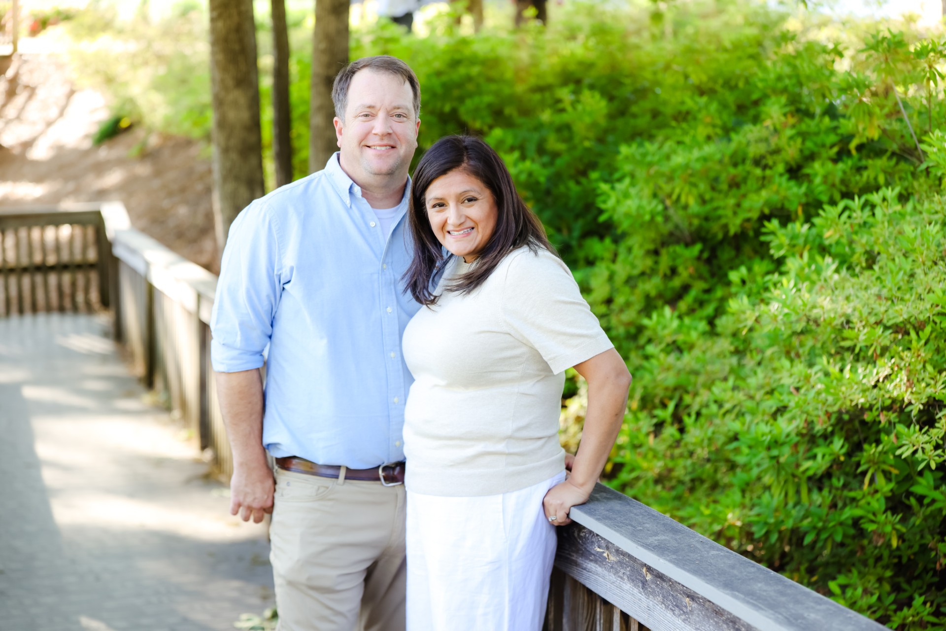 Justin and Jennifer Thomas standing together on a wooded boardwalk